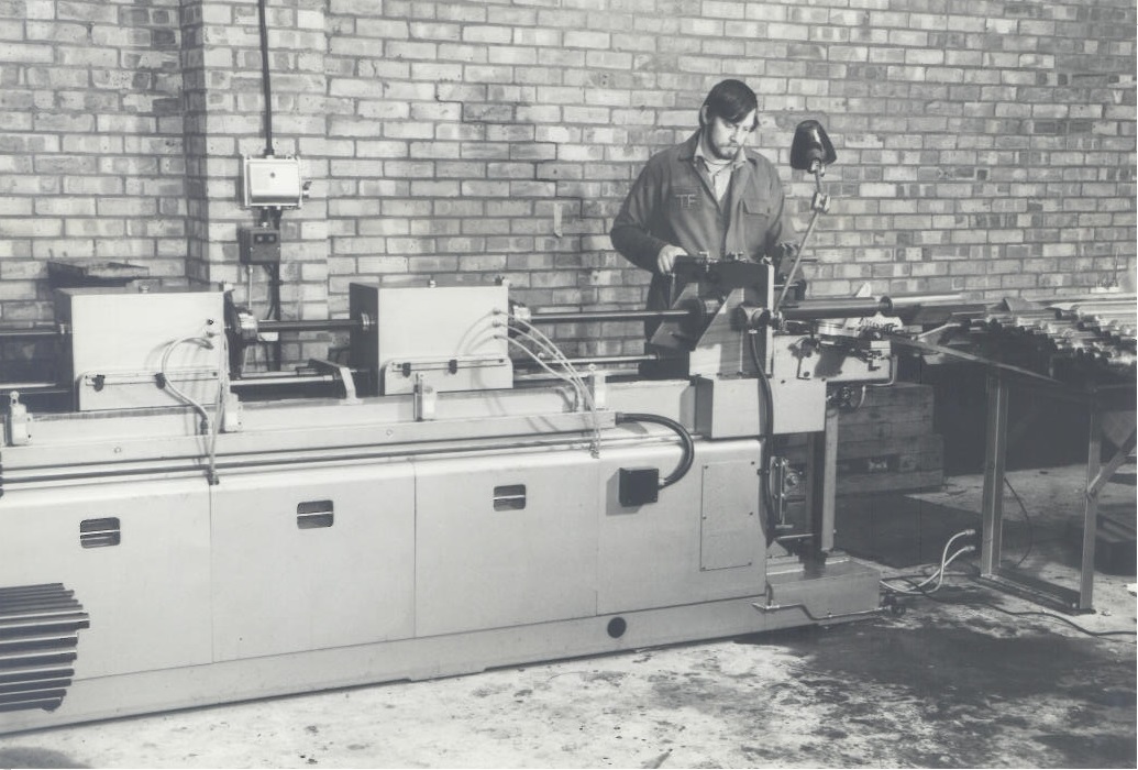Old photo of the Hercol machines being used (black and white)