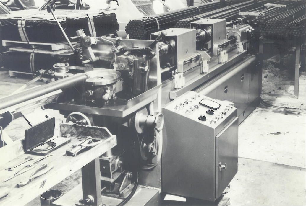 Old photo of the Hercol machines being used (black and white)
