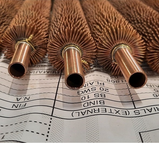 Image of a wire wound tube sat on top of its technical drawing.